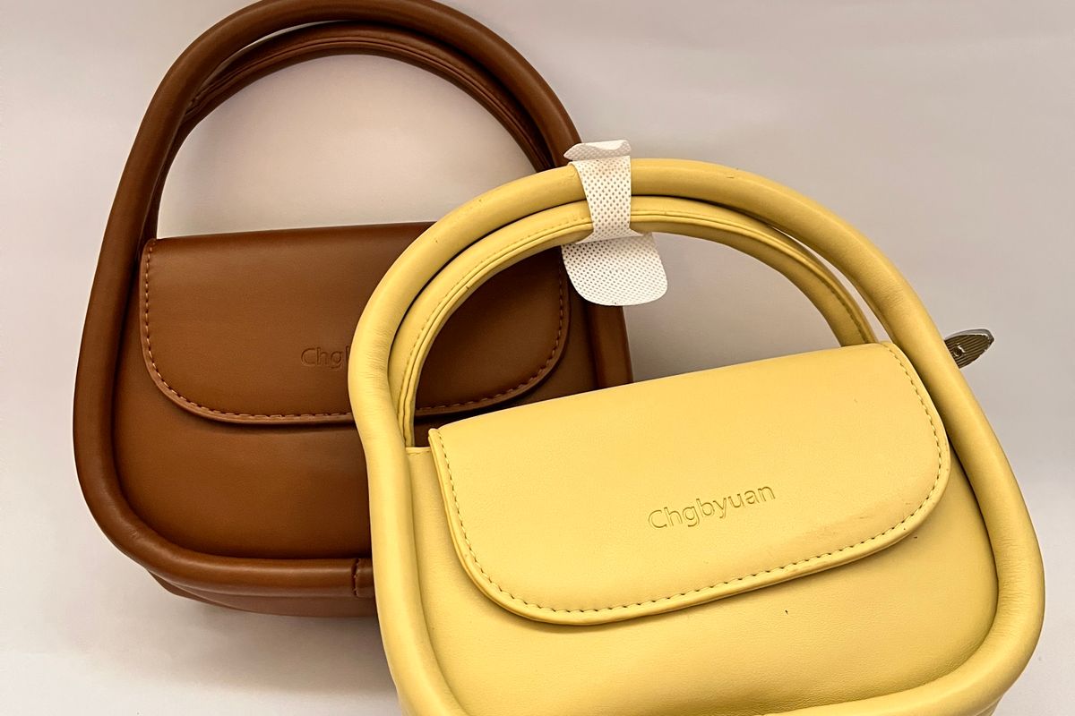Two leather handbags on a white background